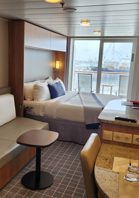 Following the 2020 "Revolution" upgrade, the cabins on the Celebrity Silhouette offer a sleek, boutique-hotel aesthetic featuring clever storage solutions like over-bed cabinetry that keeps your living space clutter-free. The real luxury, however, is the relocation of bulky lifejackets to the muster stations, which reclaims a massive amount of closet real estate for your vacation wardrobe.