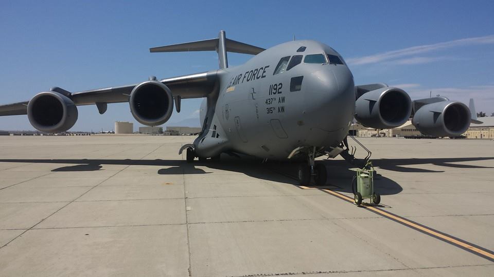 Inside you’ll find:
• Webbed airline-style seats along the fuselage
• A loud engine roar that never quite disappears
• Five-point harnesses for takeoff
• Cargo strapped down in the middle of the aircraft
• Crew members who have seen everything